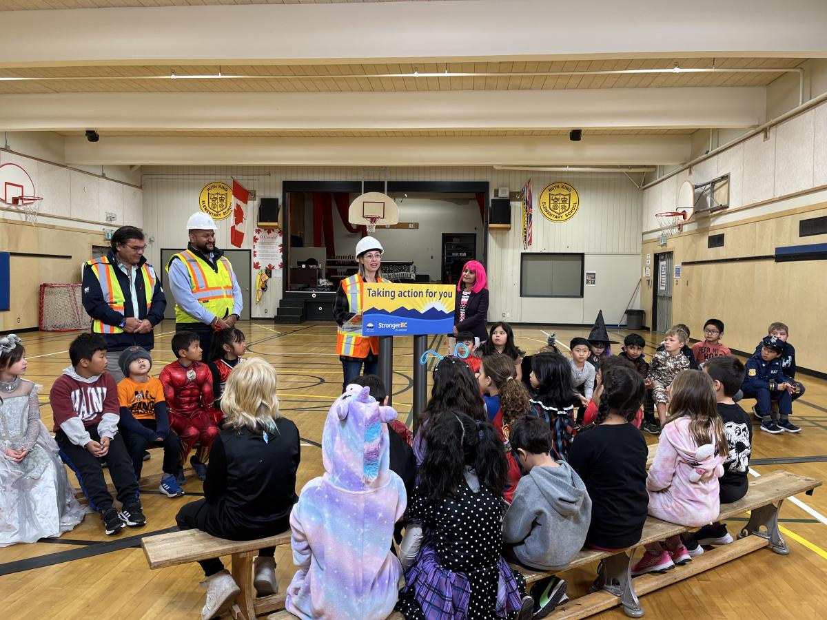 Picture of adults and children in a school gym.