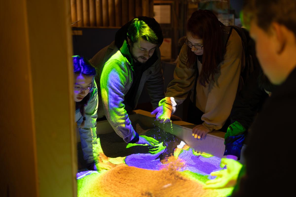 Picture of a teacher with students.