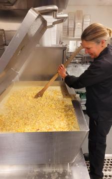 Picture of a chef making chicken noodle soup. 